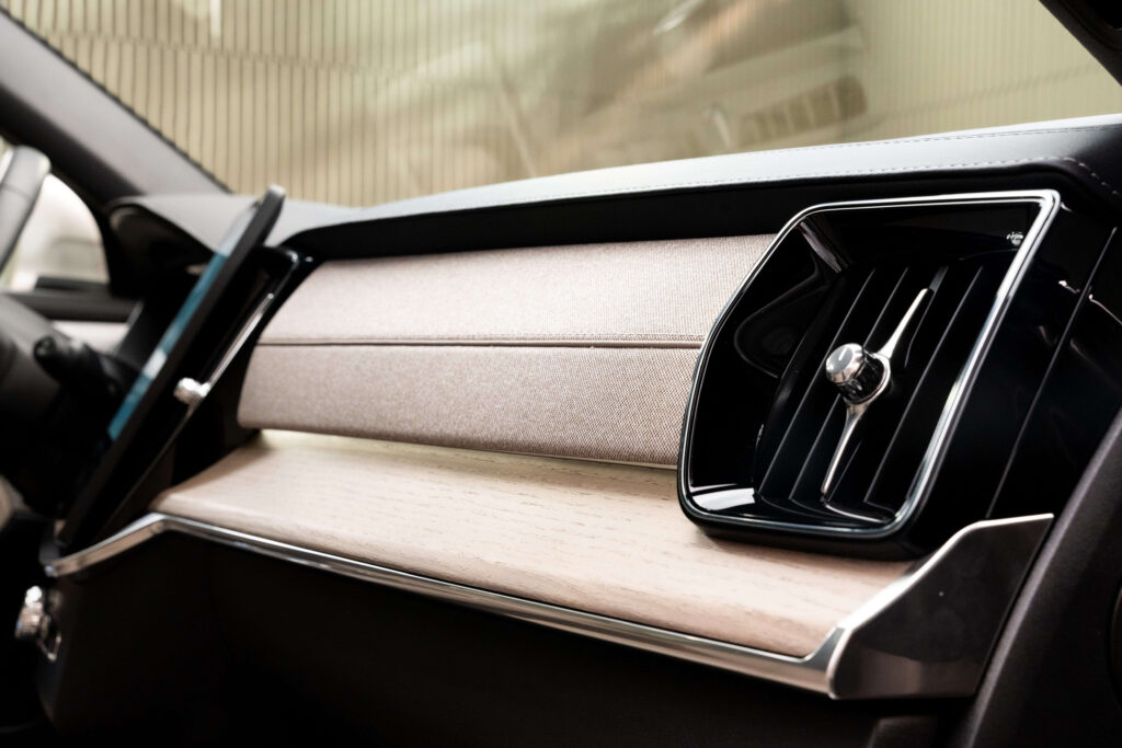 Volvo XC90:n sisätilan lähikuva kojelaudasta, etualalla viilukoristelu ja ilmanvaihtoaukko.